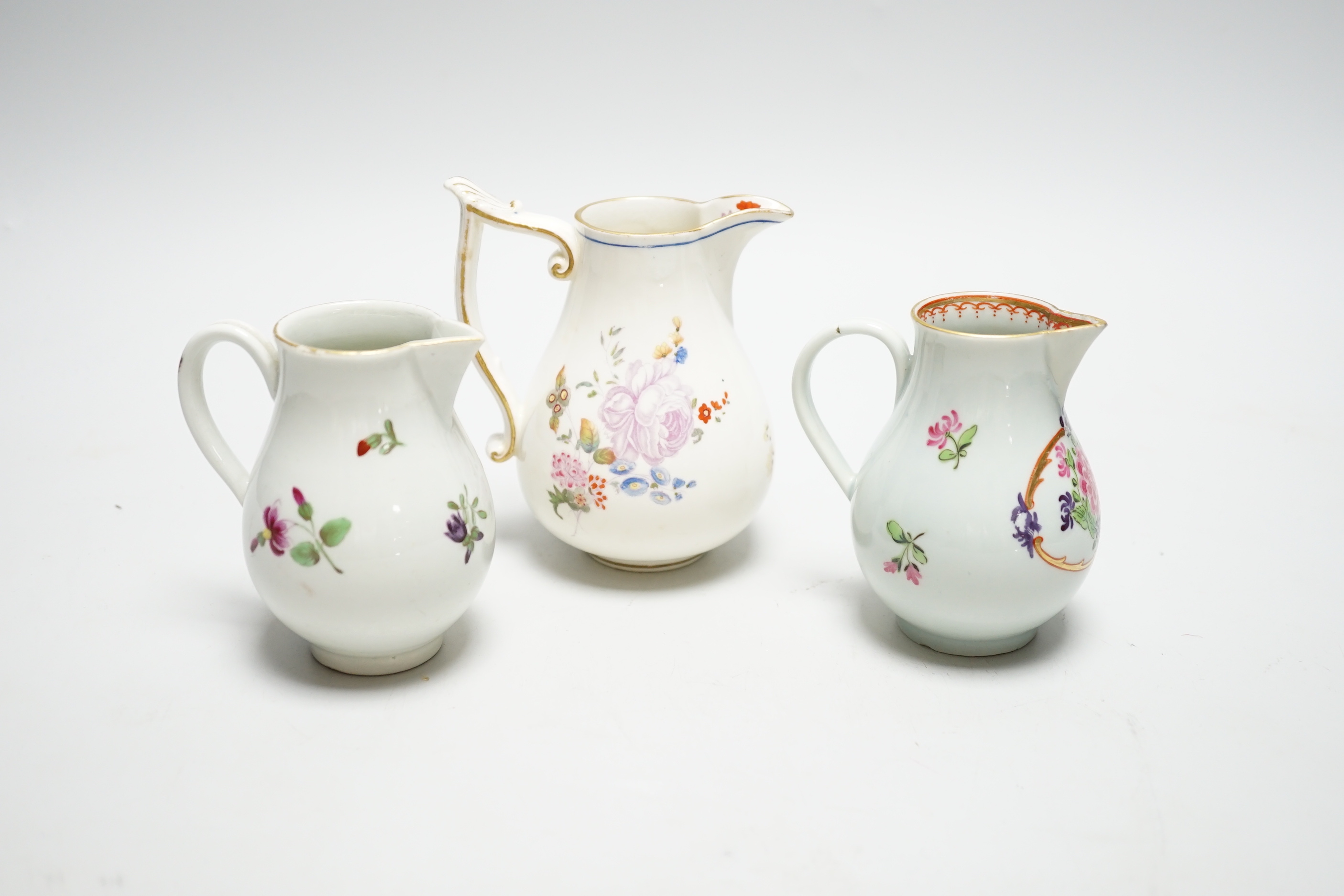 Two Worcester flower painted sparrow-beak jugs, c.1780 and an English porcelain milk jug, c.1825 (3)